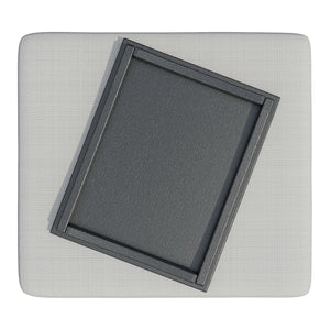 Overhead view of the ottoman's light gray cushion with the black poly serving tray set at an angle on top