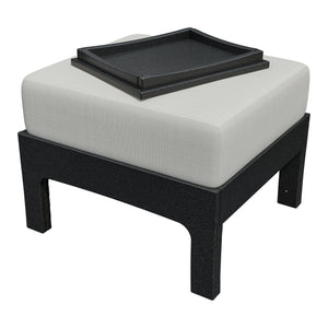 Black poly patio ottoman with a white cushion and a black hideaway serving tray placed on top