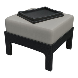 Angled view of the black poly ottoman with light gray cushion and black tray with raised rim