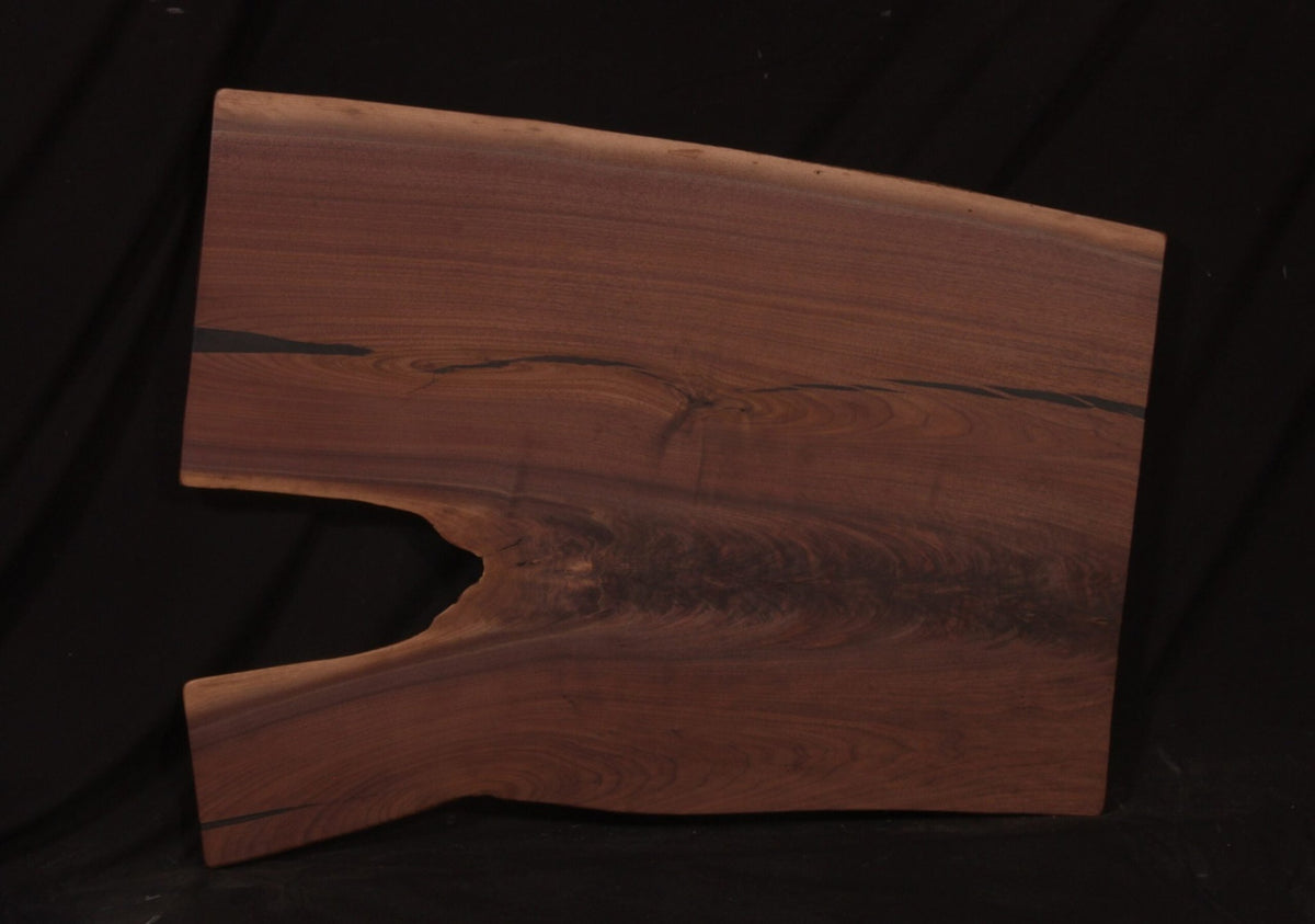 Walnut live edge coffee table slab 45 inches long and 30 to 36 inches wide with a natural notch and dark mineral streaks