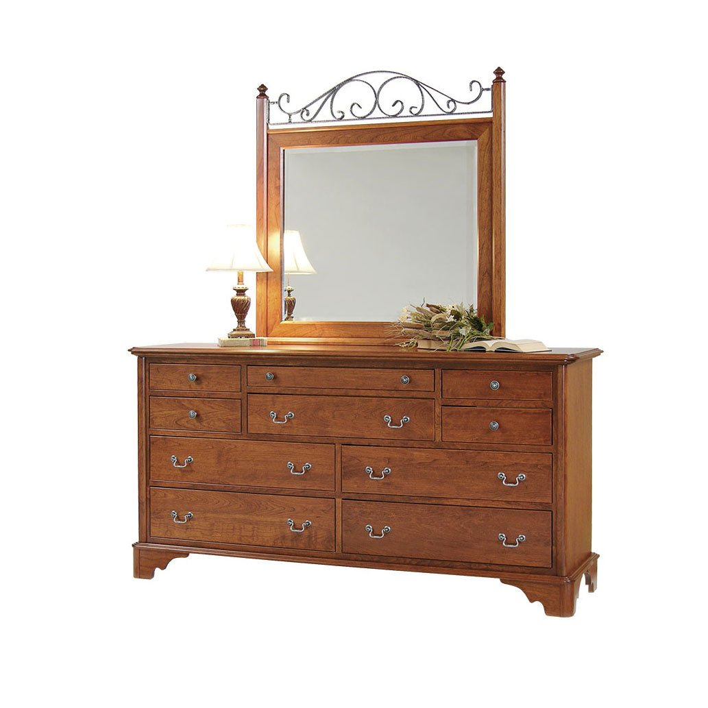 Cherry nine drawer dresser with a tall mirror topped by black iron scrollwork and bail pulls