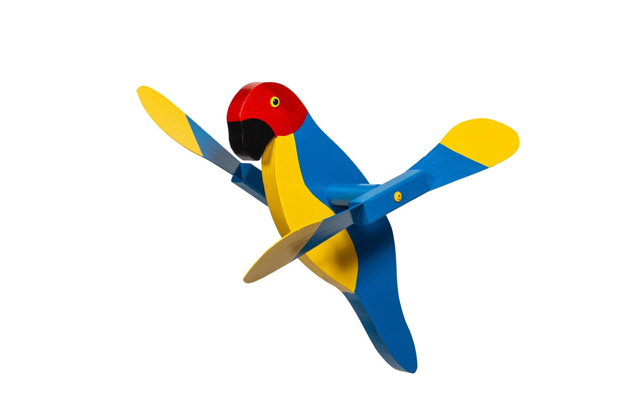 Macaw parrot whirlybird spinner in blue and yellow with a red head and yellow-tipped paddle wings, on white