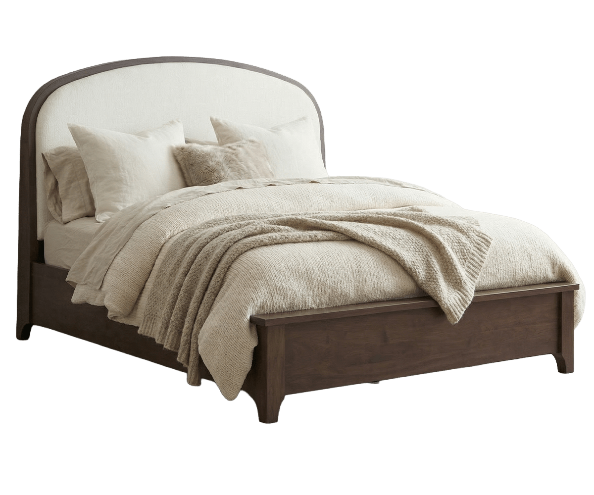 Panel bed with a curved cream upholstered headboard in a walnut frame, paneled footboard and cozy ivory bedding