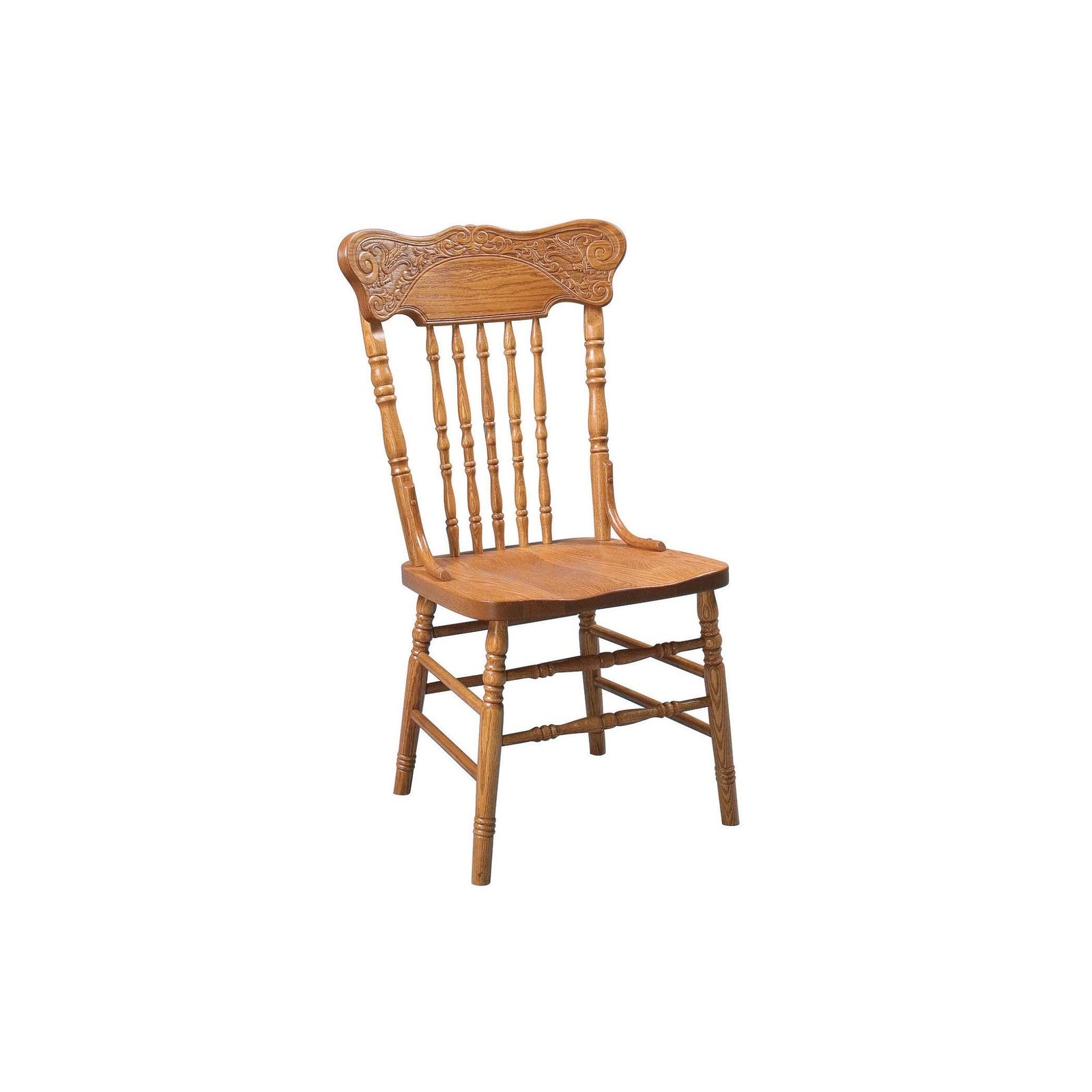 Oak pressback chairs with ornate scrolled crest carving and turned spindles at a farm table on a braided rug