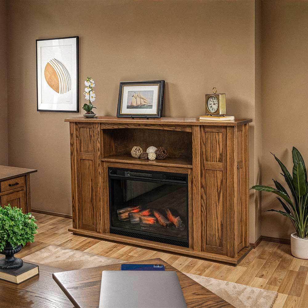 Oak fireplace mantel with electric heater insert, open display shelf and two side cabinets in a tan walled office