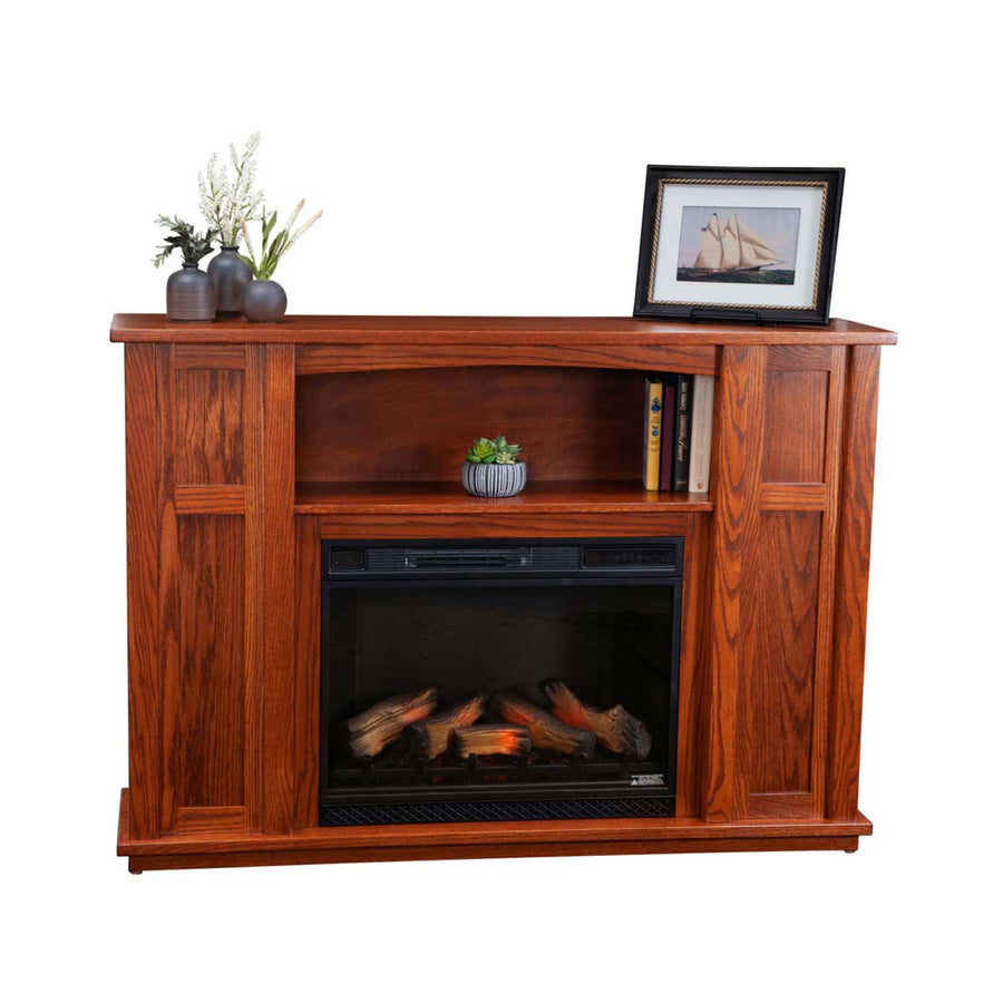 Oak fireplace mantel with an electric log heater, arched open shelf holding books and paneled side cabinets