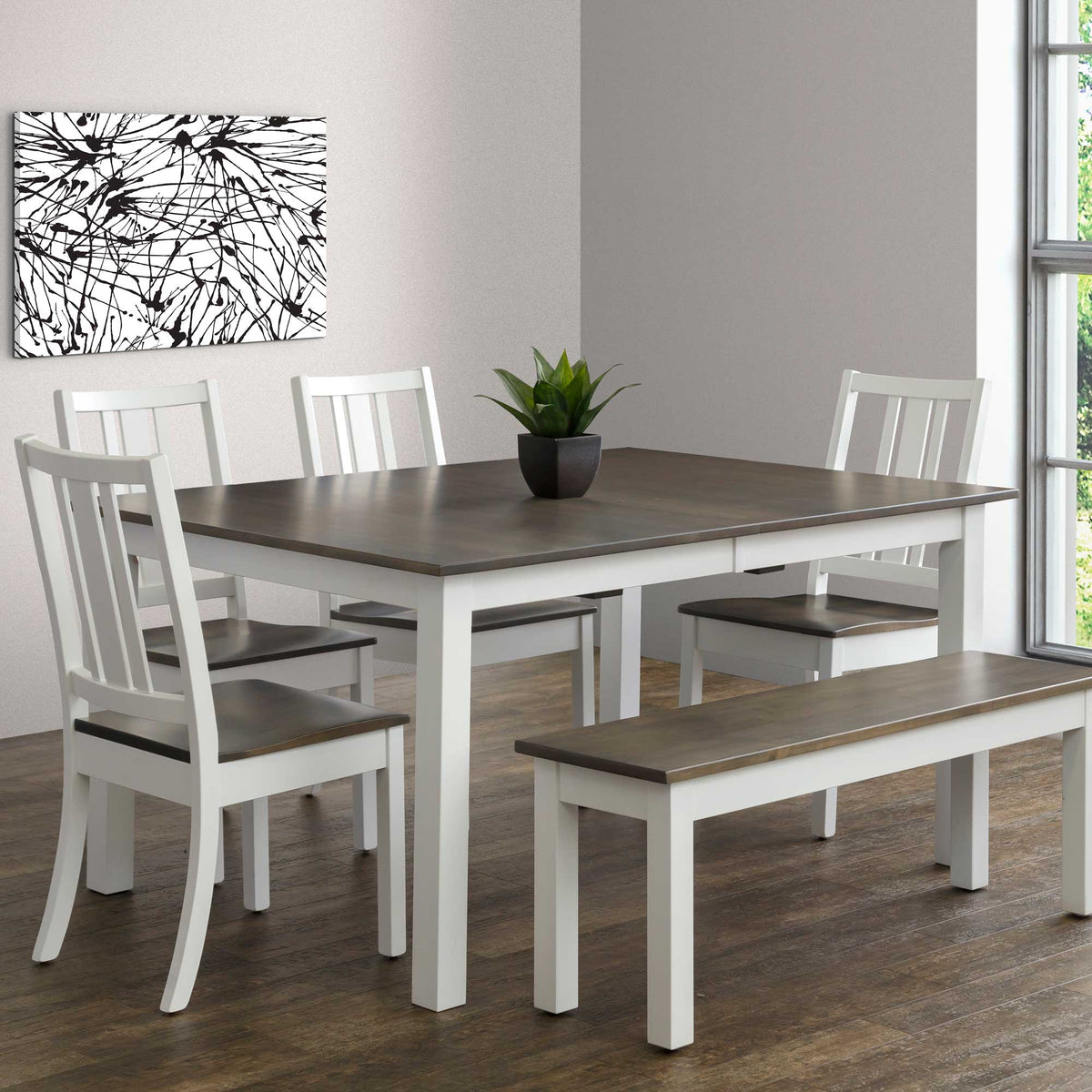 Two-tone dining set with white painted base and gray top, four slat back chairs and matching bench in a bright dining room