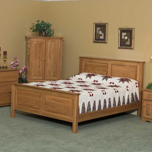 Raised panel oak bed with matching armoire, nightstand and dresser in a bedroom with green carpet