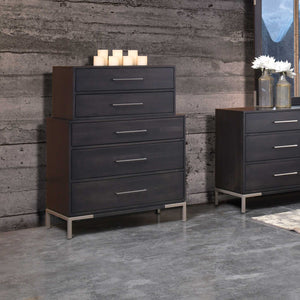 Stacked-look five-drawer chest in dark wood with silver bar pulls and candles on top beside a matching dresser