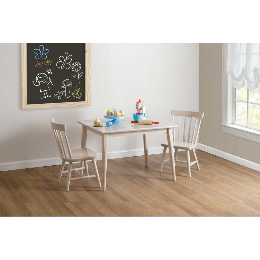 Kid's play table and chair set in whitewashed wood beside a chalkboard and window in a bright playroom