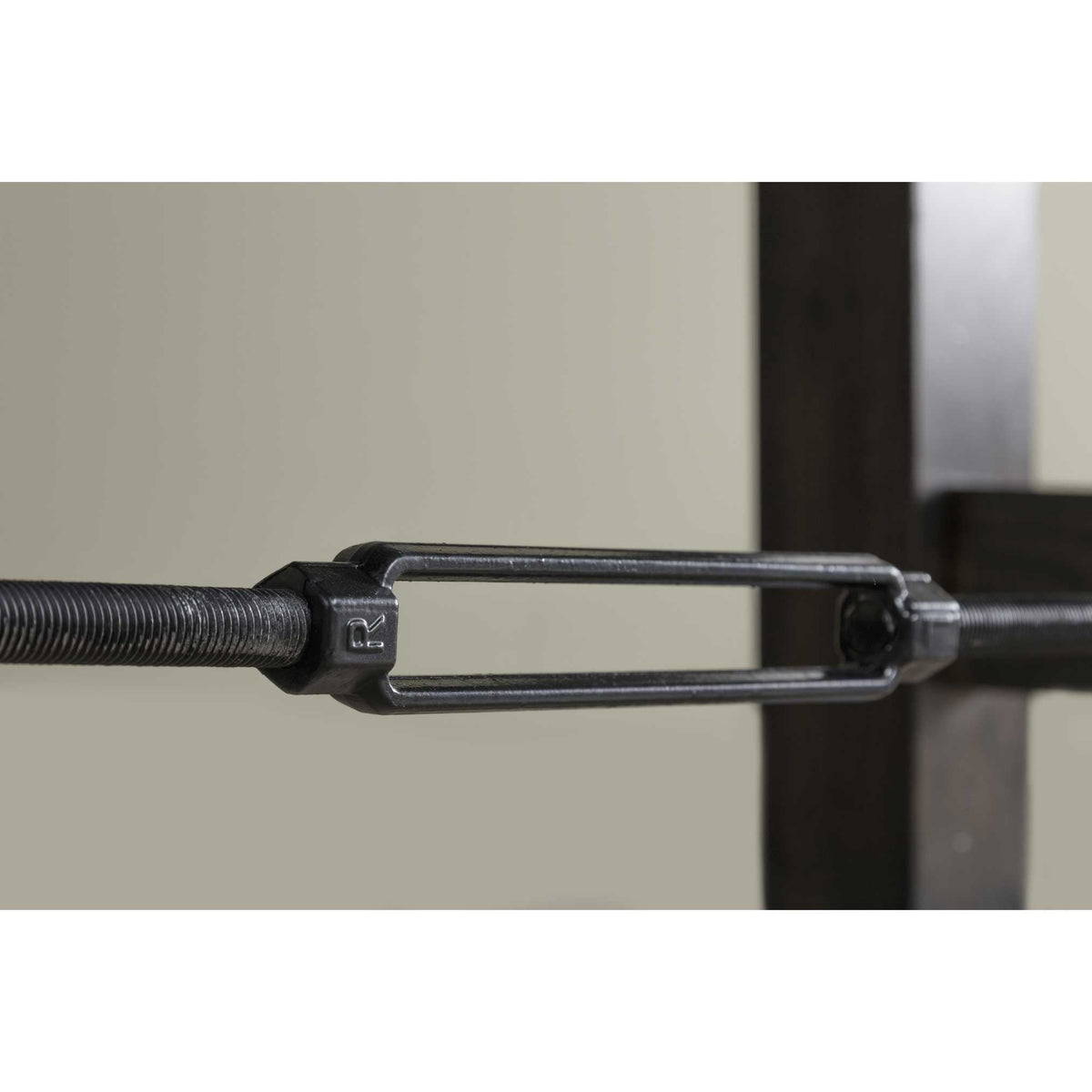 Detail of the forged iron turnbuckle joining the stretcher rods beneath the trestle table