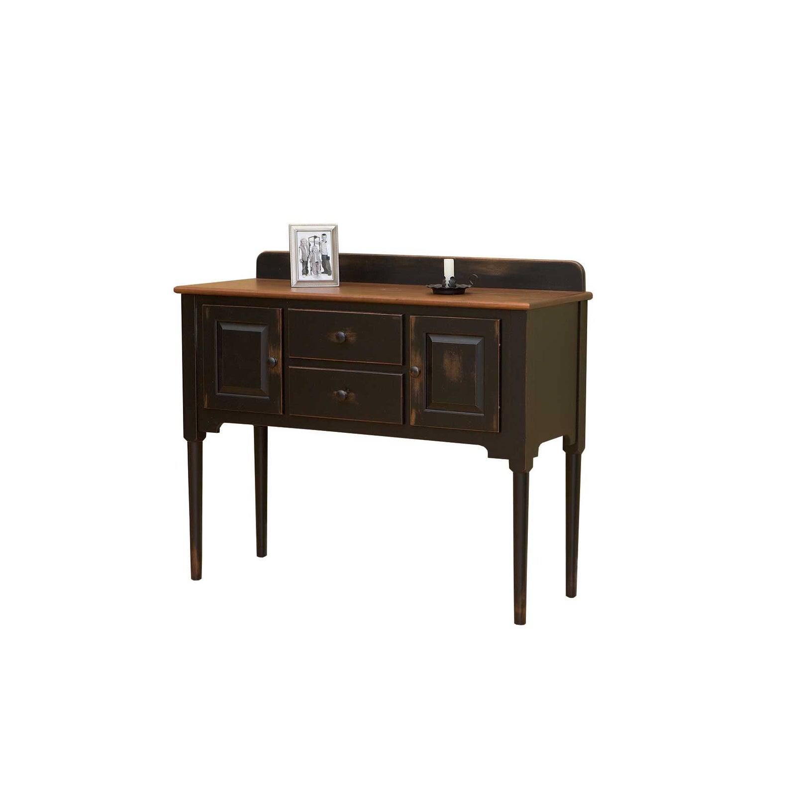 Distressed black sideboard with oak top and back gallery, two drawers, two doors and tall tapered legs in a brick dining room