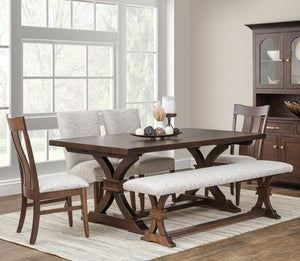 Dark walnut Sherwood trestle dining table with curved X trestle base, upholstered parson chairs, slat back chairs and bench