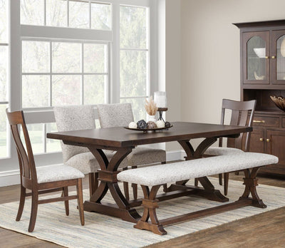 Dark walnut Sherwood trestle dining table with curved X trestle base, upholstered parson chairs, slat back chairs and bench