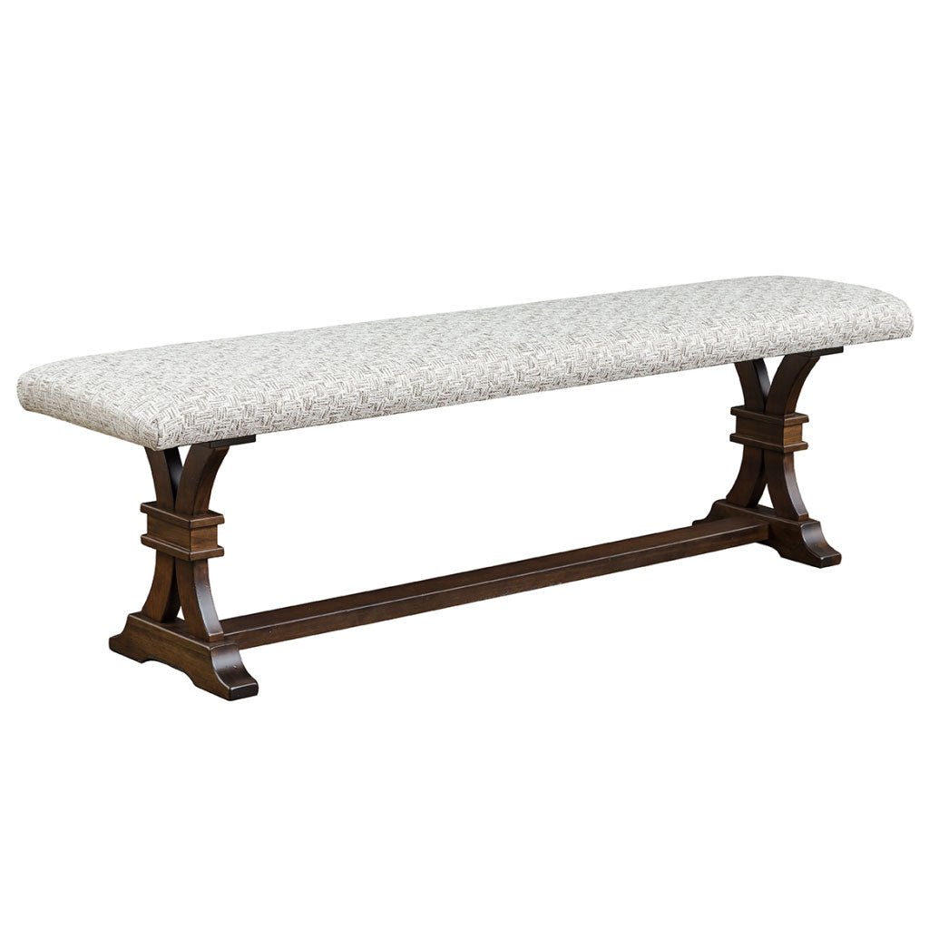 Upholstered dining bench with light gray tweed seat on a dark walnut curved trestle base with center stretcher