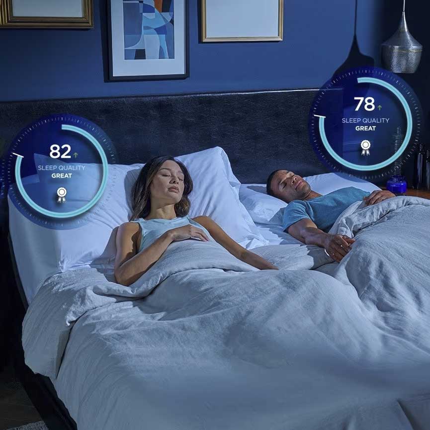 Sleeping couple under white bedding with glowing sleep quality score dials of 82 and 78 floating above the bed