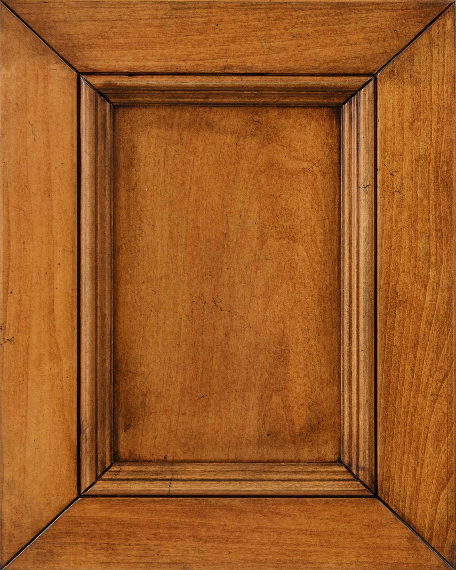 Vintage Yukon stain on maple wood sample, a mellow amber panel door with darker antiqued molding and smooth maple grain
