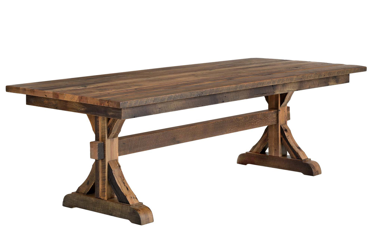 A rustic rectangular wooden dining table with a trestle base and a thick apron support beam, shown on a plain white background.