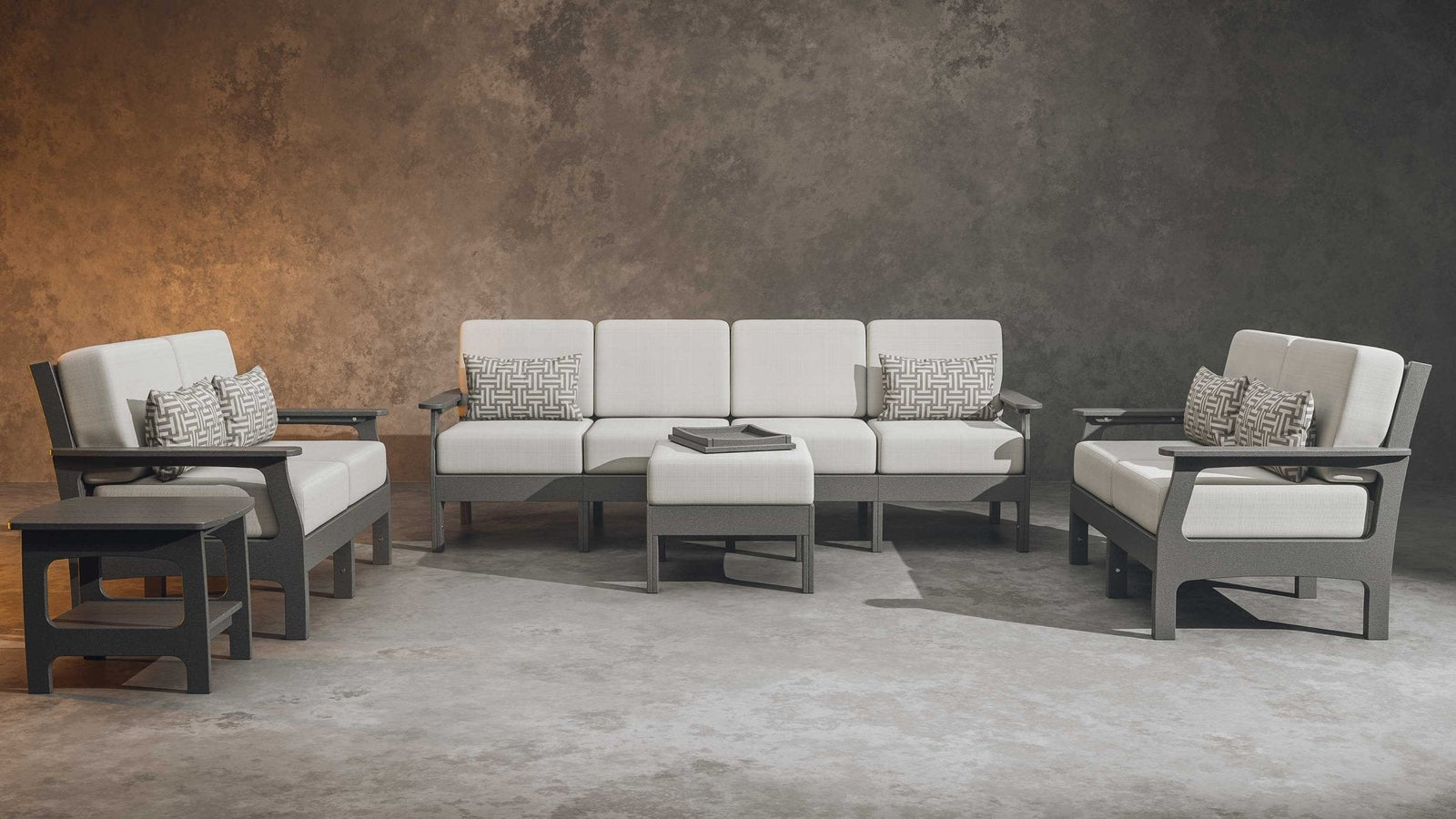 Gray poly patio set with white cushions: four seat sofa, two club chairs, tray ottoman and side tables indoors