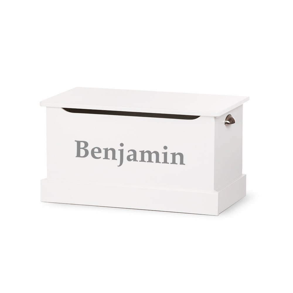 White wooden toy chest personalized with the name Benjamin in gray serif lettering and a metal side handle
