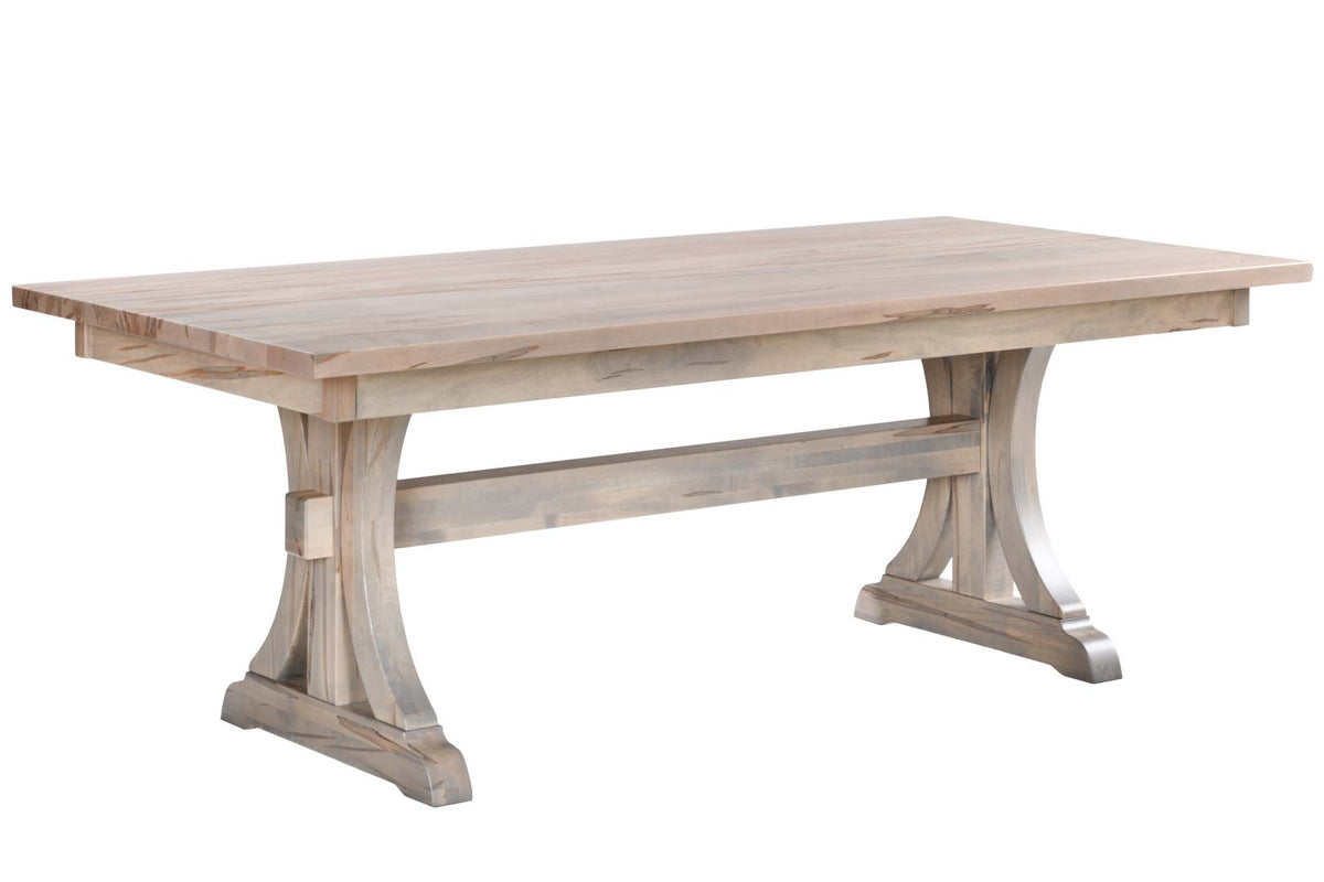 A rustic rectangular wooden dining table with a weathered light gray-brown finish, featuring a thick top and trestle-style legs, shown on a plain white background.