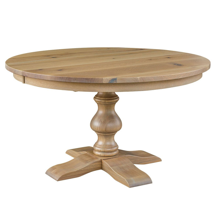 Round Alana pedestal dining table in light natural oak with a chunky turned column and four-arm curved pedestal foot
