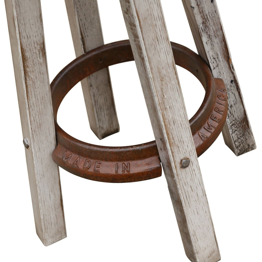 Close up of the bar stool's cast iron footrest ring stamped Made in America between whitewashed legs