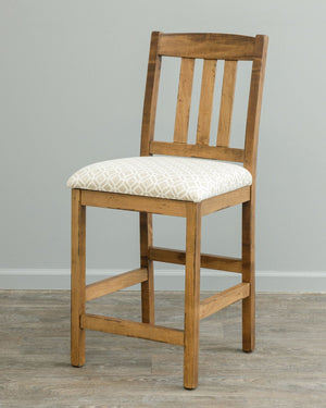 Rustic maple counter stool with three back slats and a cream geometric patterned upholstered seat
