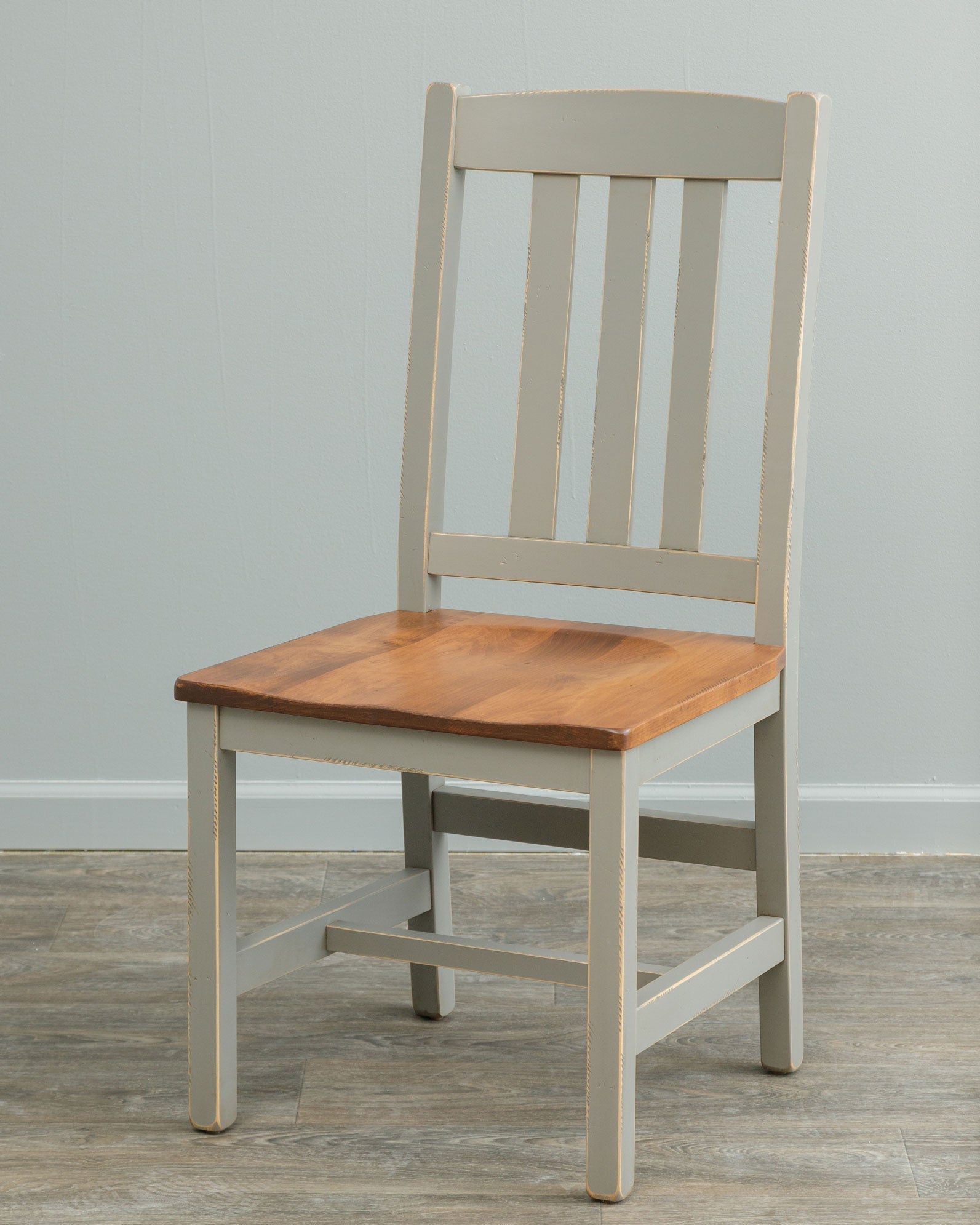 Gray painted dining chair with three back slats and a contrasting natural wood saddle seat