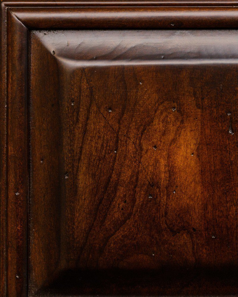 Teak Antiquity level 1 stain on cherry, a glossy reddish brown panel with light distress marks