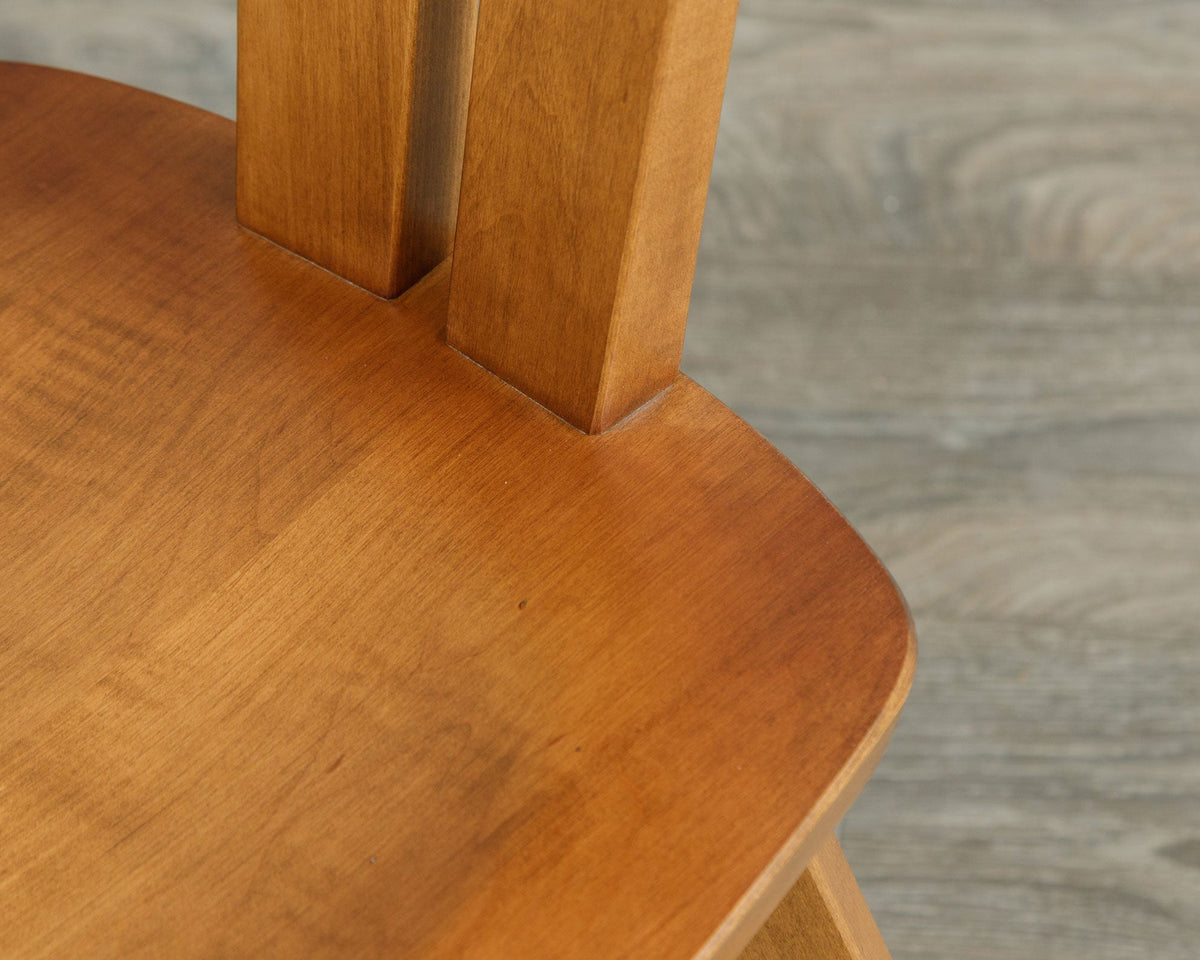 Close view of the twin back splats joining the contoured saddle seat on an Astoria mid century chair