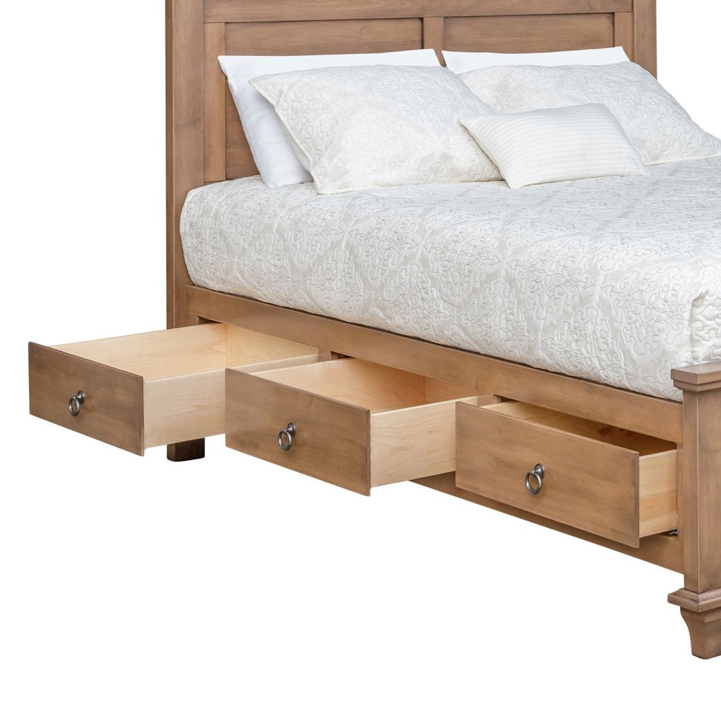 Captain storage bed with three under-bed drawers open showing maple drawer boxes below the white bedding