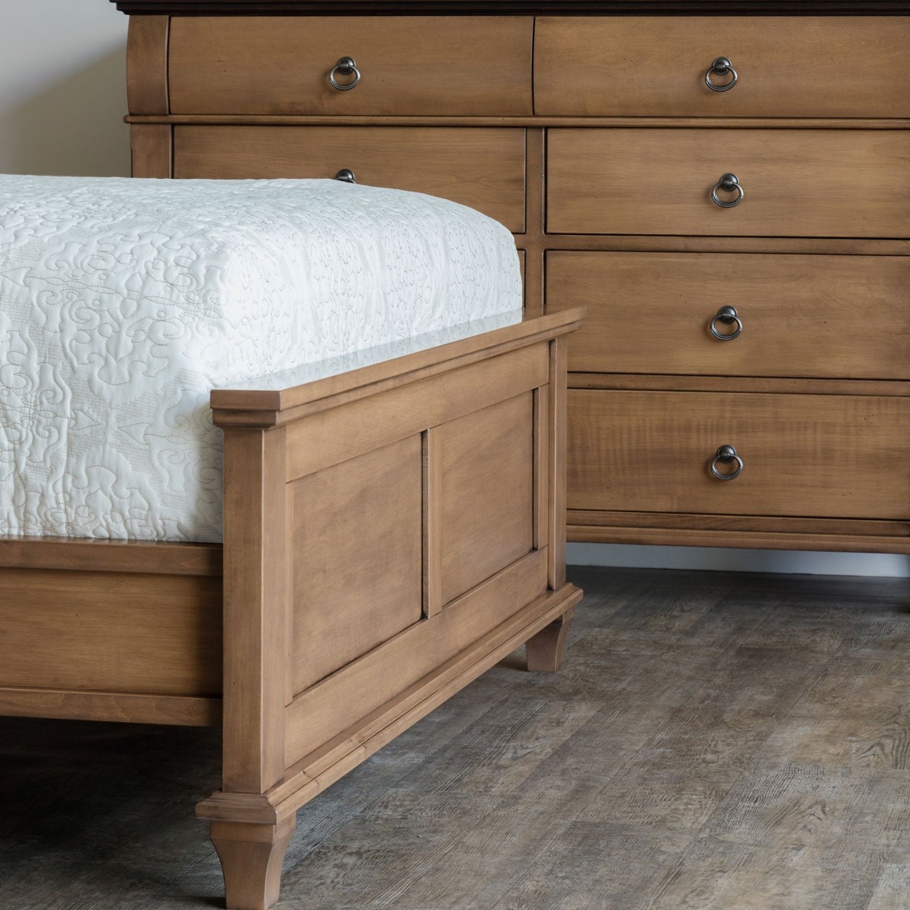Light almond panel bed with a black diamond iron lattice headboard insert, panel footboard and tapered posts
