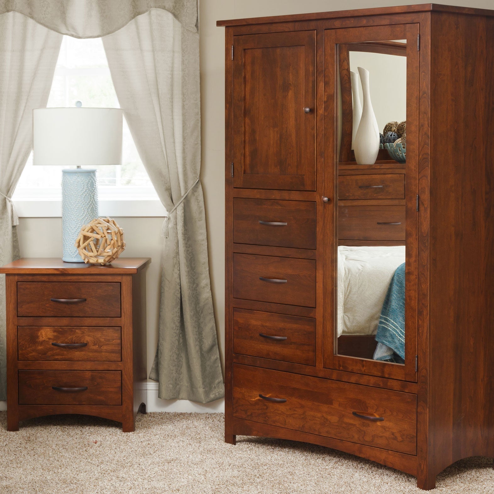 Cherry chiffonier with a mirrored door, upper panel door, four drawers and a wide bottom drawer beside a nightstand