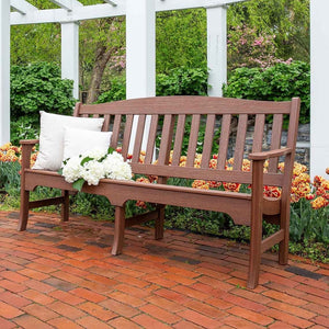 Long mahogany brown poly garden bench with an arched slat back and armrests, on a brick patio