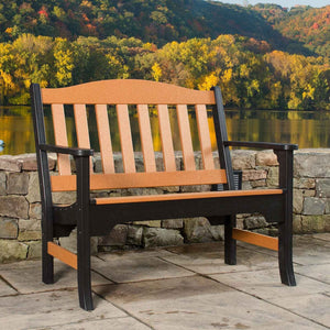 Two tone cedar and black poly garden bench with arched slat back on a stone patio above a lake