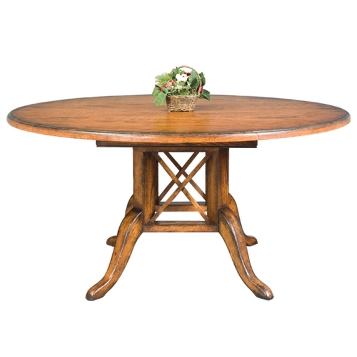 Round birdcage pedestal dining table in medium oak with four upholstered back chairs on a soft gray rug