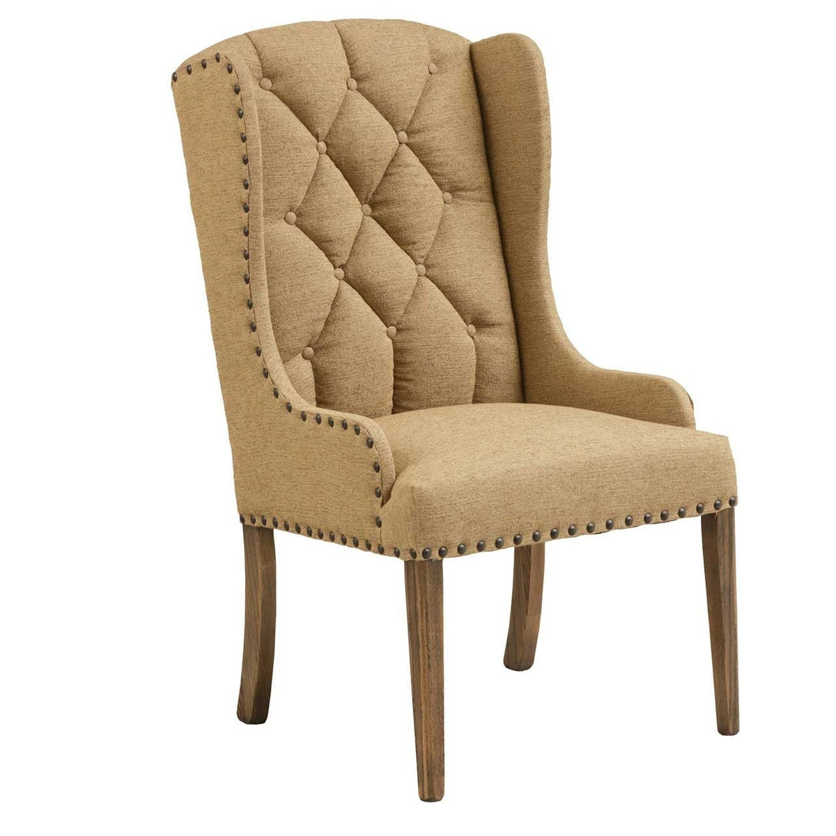 Tall upholstered dining armchair in camel tan fabric with diamond tufted back, dark nailhead trim and distressed wood legs