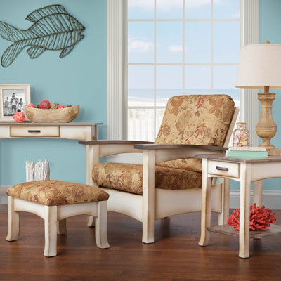 Coastal Morris chair with floral cushions and cream painted frame paired with an ottoman in a beach themed room