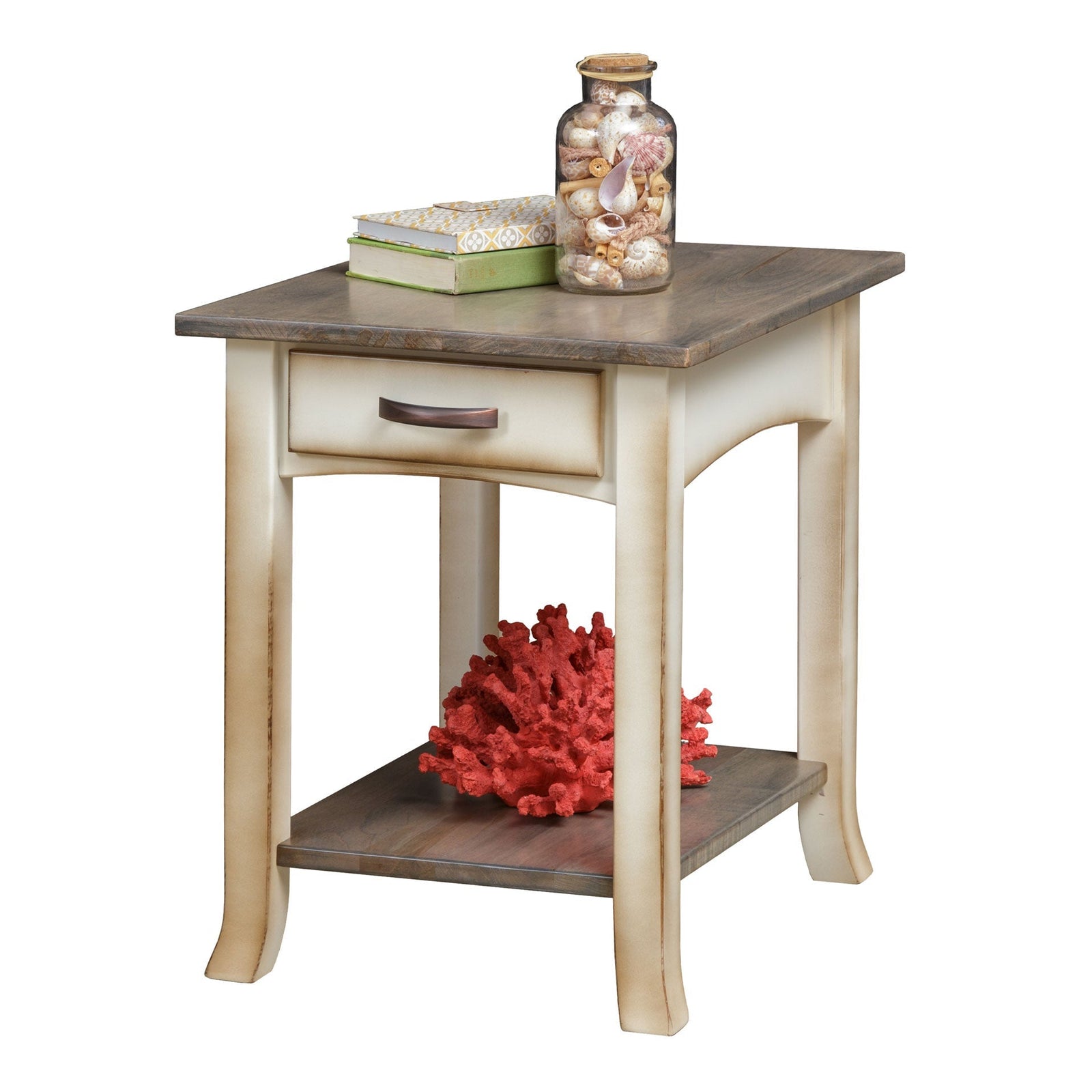 Coastal end table with weathered gray top and cream base holding a lamp and shells in a beach themed living room