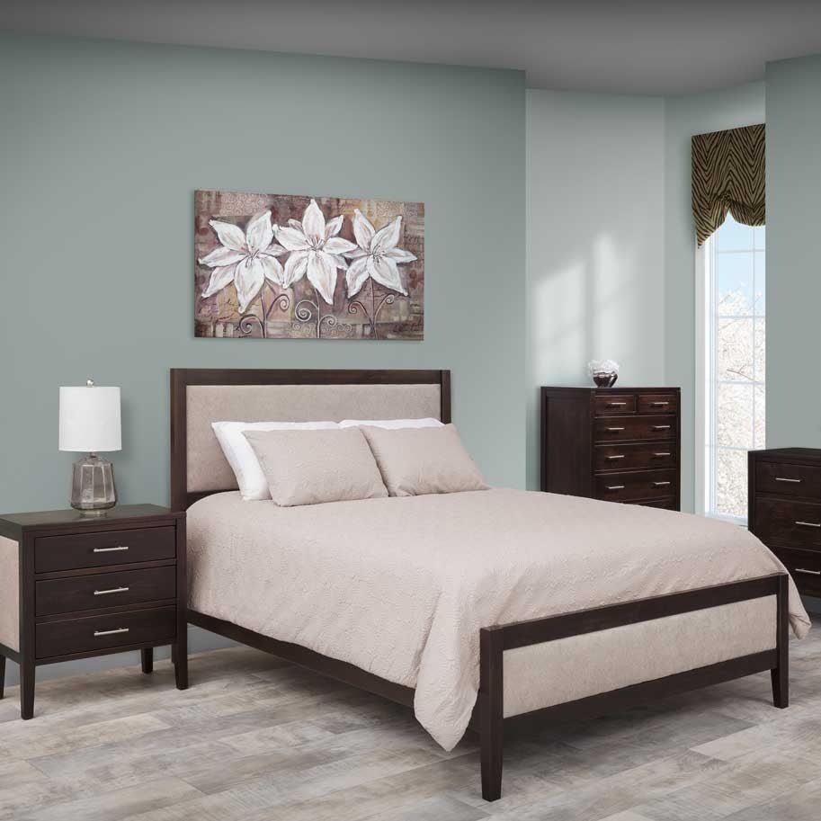 Espresso bed with an upholstered cream headboard panel styled with a floral canvas, nightstand and tall chest