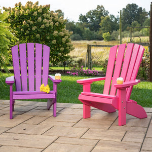 Purple and pink kids poly Adirondack fanback chairs with cupcakes on the wide arms on a paver patio