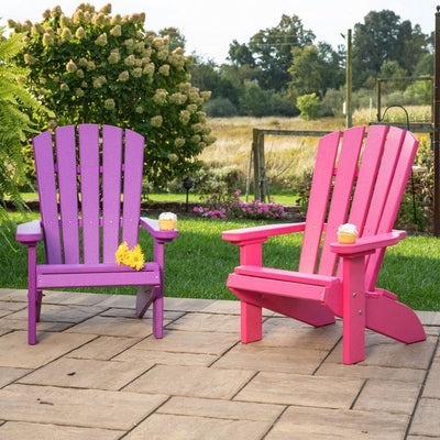Purple and pink kids poly Adirondack fanback chairs with cupcakes on the wide arms on a paver patio