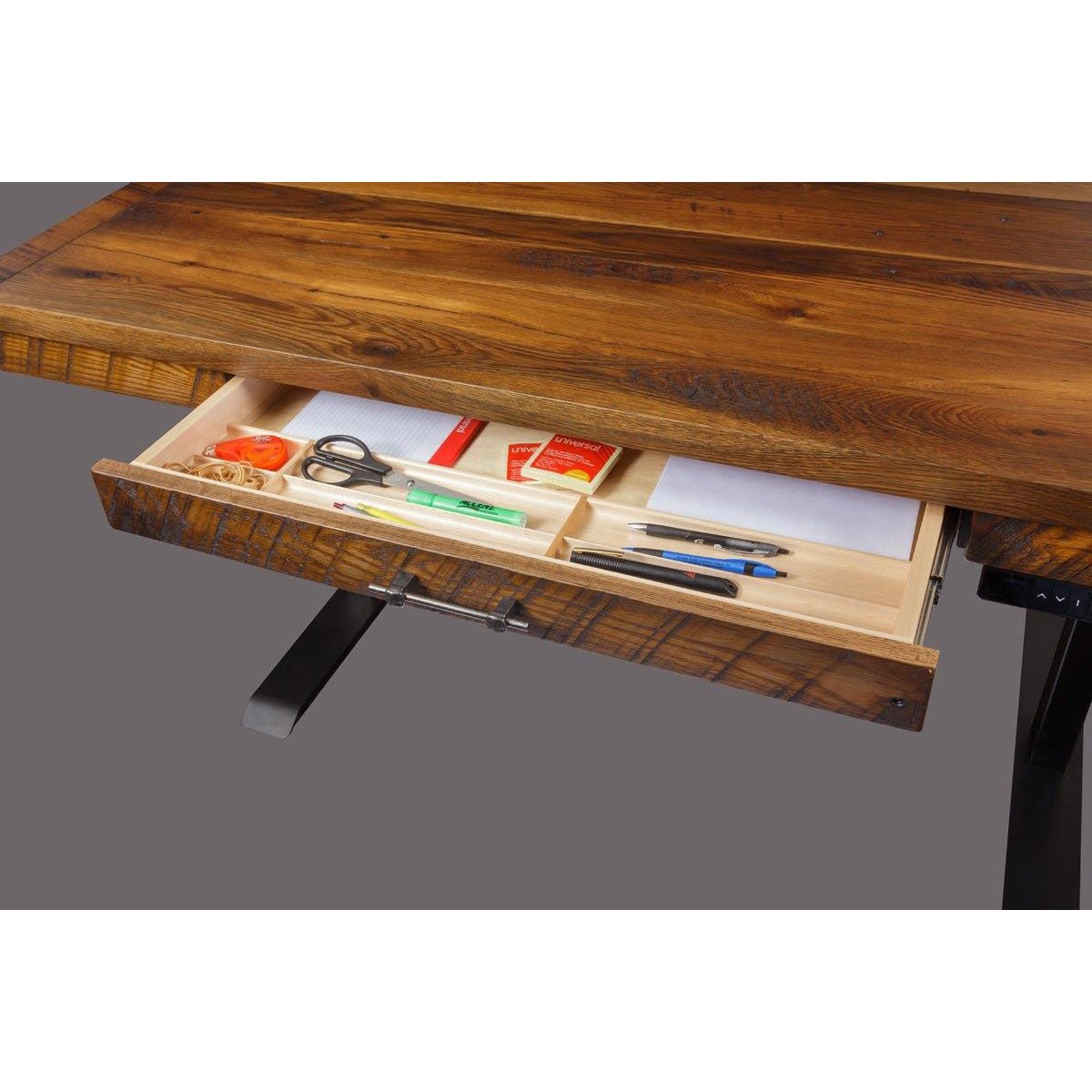 Open drawer of the reclaimed wood lift desk showing a maple organizer tray with pens, scissors and paper