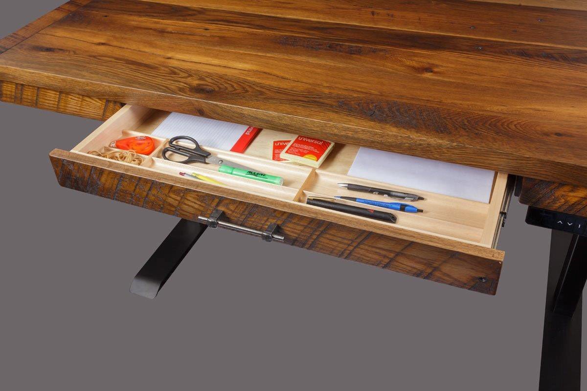 Reclaimed wood lift desk drawer open on its slides, showing a maple tray with pens, scissors and notepads