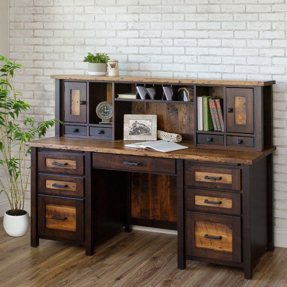 Reclaimed wood double pedestal hutch desk with six drawers, letter slots and small drawers against white brick