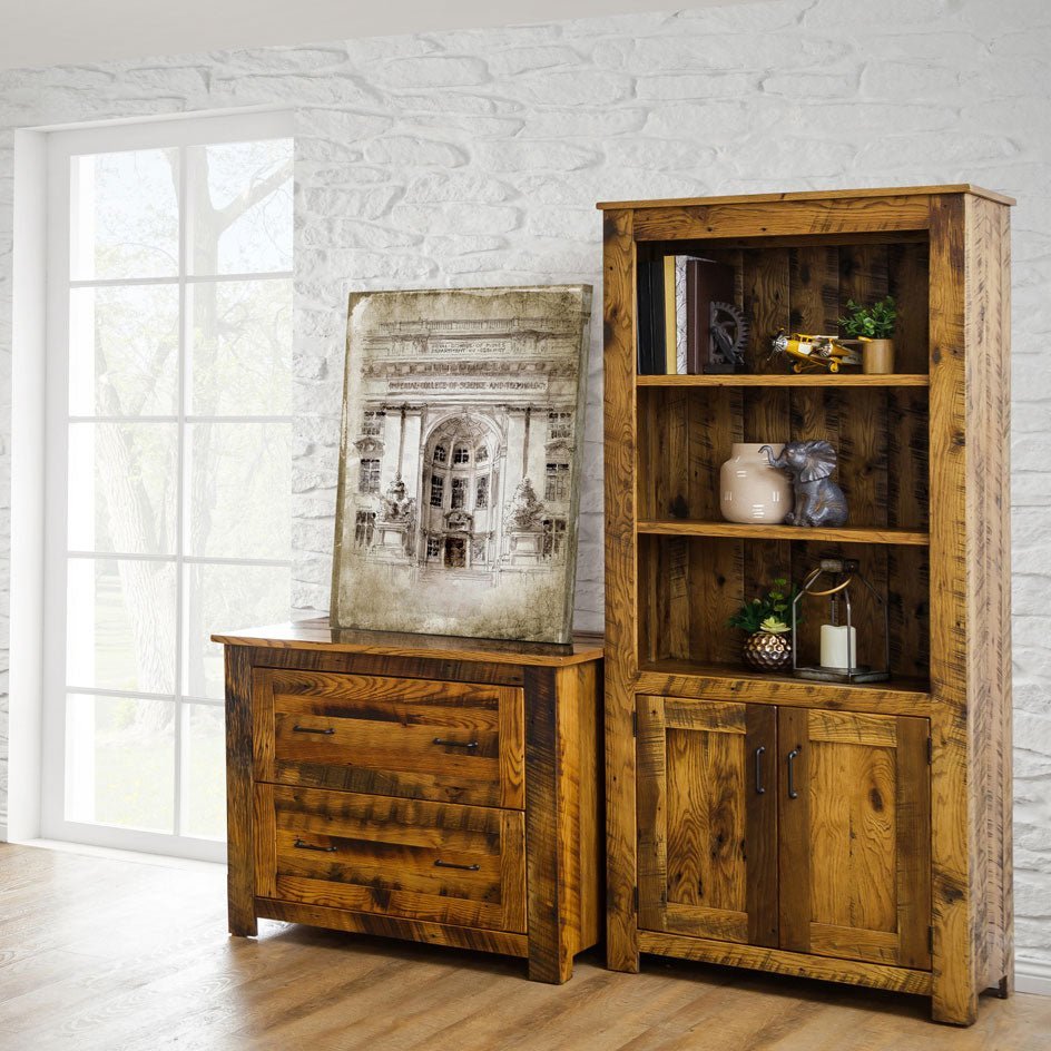 Rustic reclaimed wood bookcase with three open shelves over a two-door cabinet, next to a matching lateral file by a window