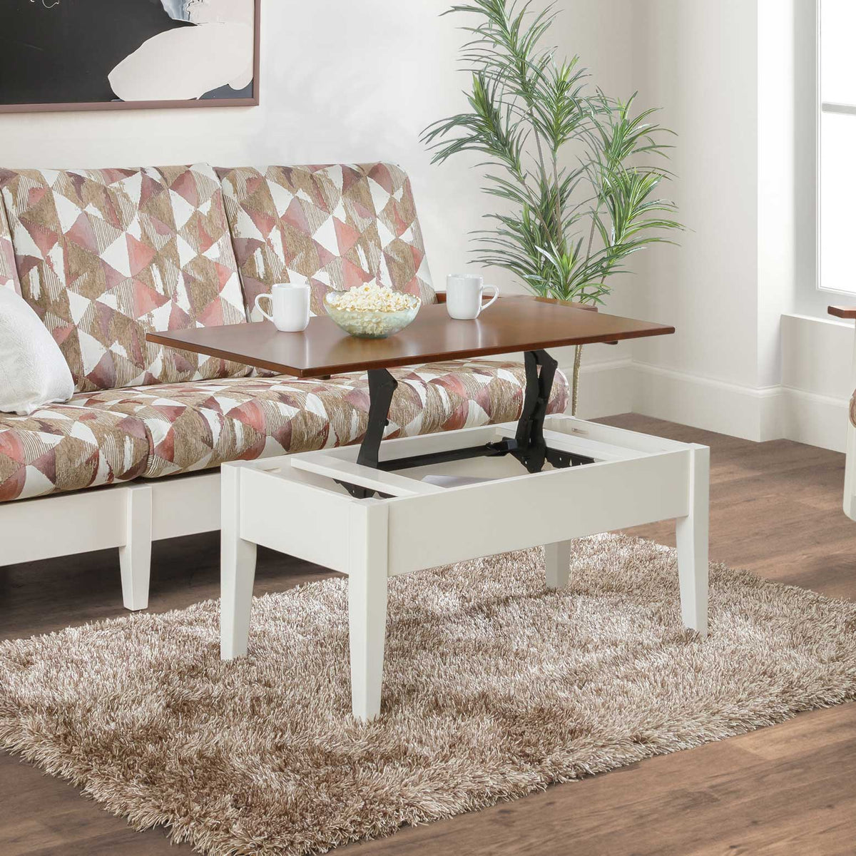 White painted Shaker lift top coffee table with cherry-stained top raised on a hinged mechanism, styled beside a patterned sofa on a shag rug