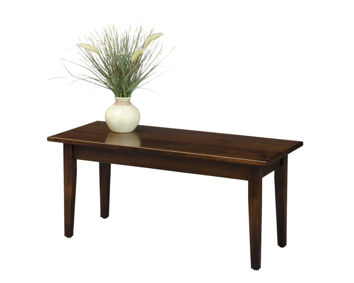 Small solid wood Shaker coffee table in brown stain with a decorative vase, shown on a white background