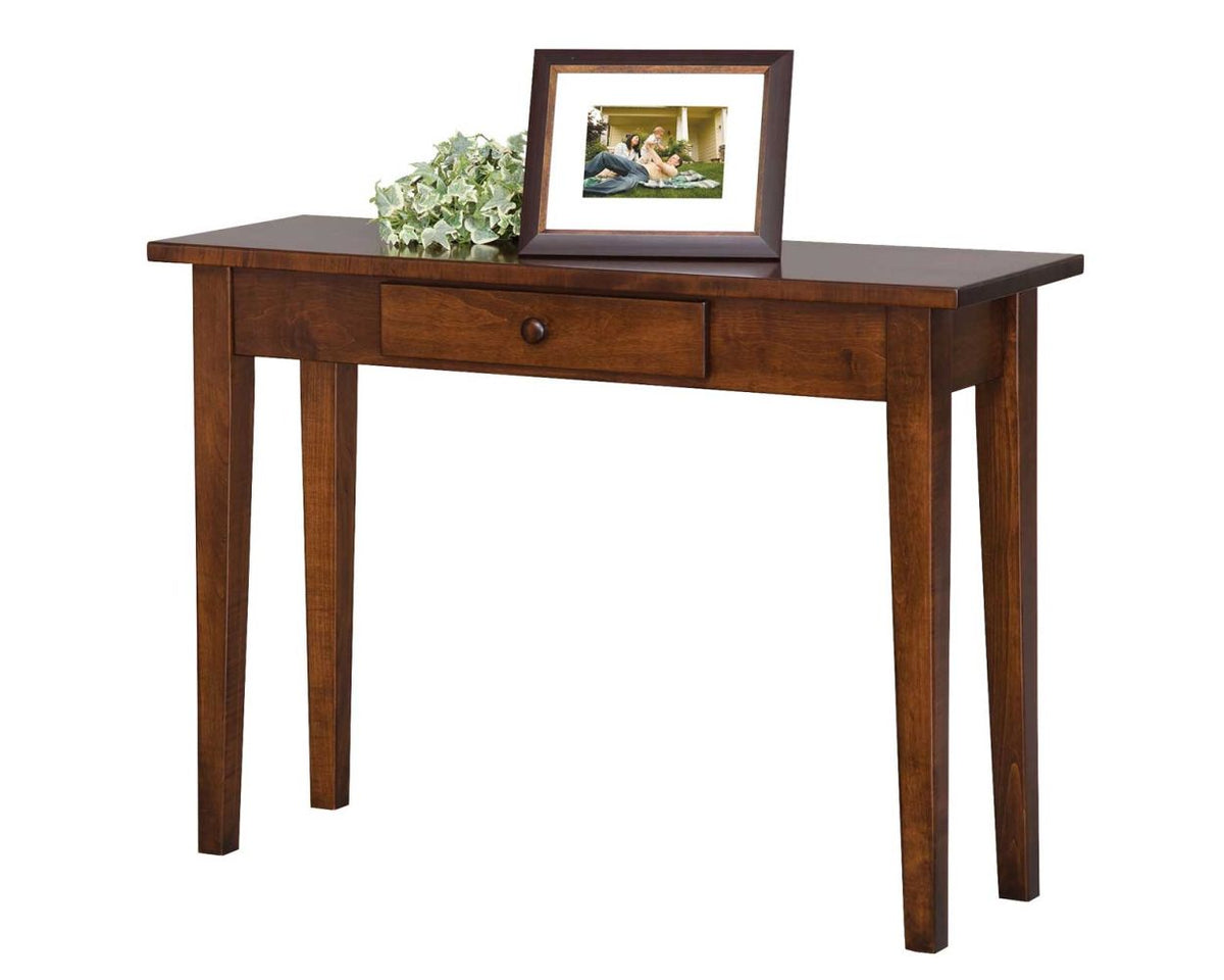Cherry Shaker console table with a single center drawer and wooden knob, holding a framed photo and ivy garland